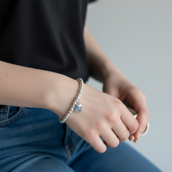 Silver plated beaded bracelet with a piece of raw aquamarine attached
