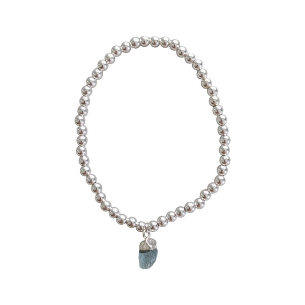 Silver charm bracelet with natural aquamarine charm attached 