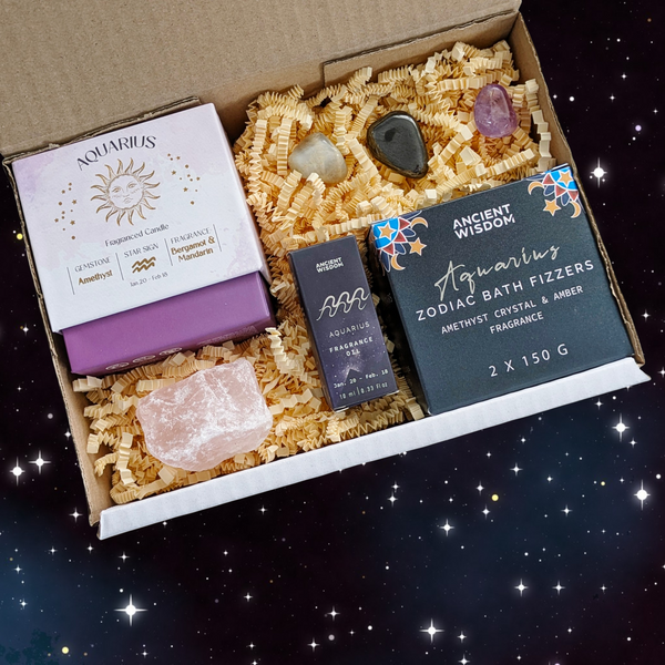 Aquarius Gift Box filled with crystal candle, two bath fizzers, fragrance oil, three crystal tumblestones and a piece of raw rose quartz. 