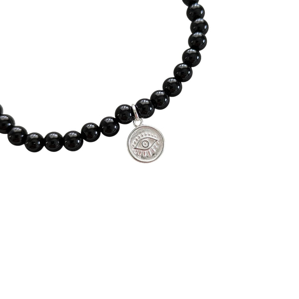 925 Sterling Silver Evil Eye Charm close up on a Black Agate beaded crystal bracelet