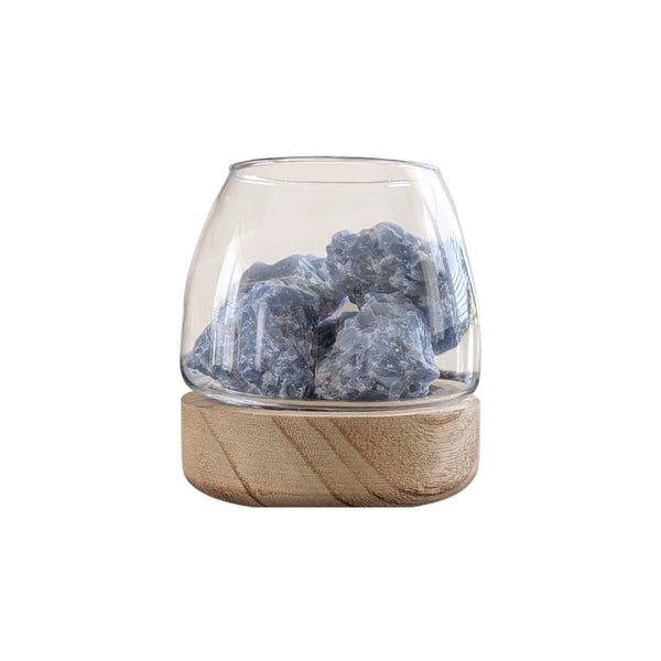 diffuser made using natural raw blue calcite crystals in a glass pot on a tung wood base. 