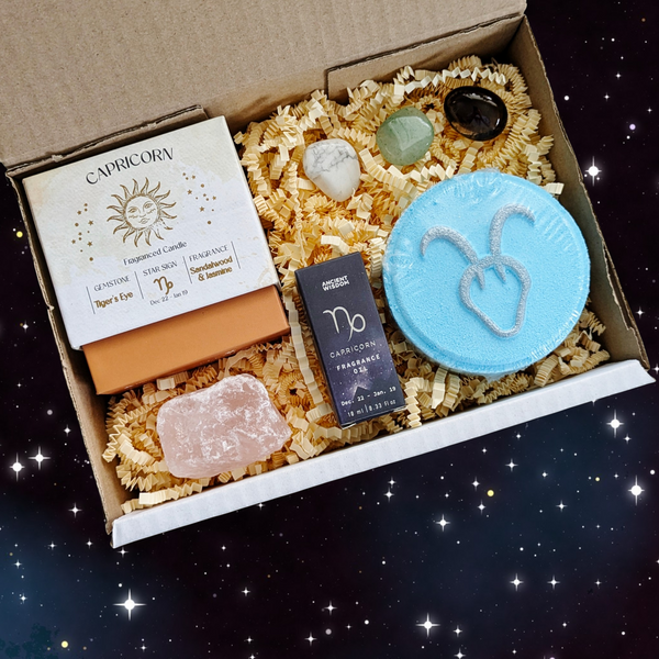 Capricorn gift box including; crystal candle, bath bomb, fragrance oil, raw rose quartz and crystal tumblestones. 