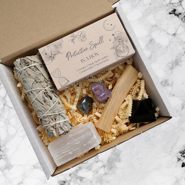 Protection spell, palo santo, black obsidian pyramid, amethyst cluster, hematite crystal, white sage stick, selenite stick in a gift box to cleanse and protect energy and space.