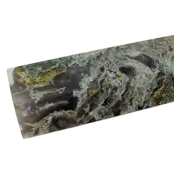 green inclusions in a green moss agate polished point