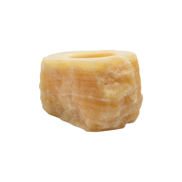 Orange calcite tea light holder with rough edges and a polished top 