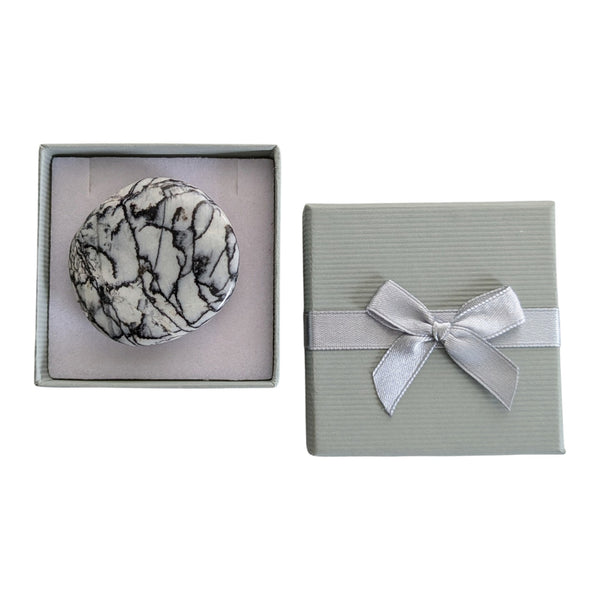 Net Jasper palmstone in a grey gift box with ribbon detail.