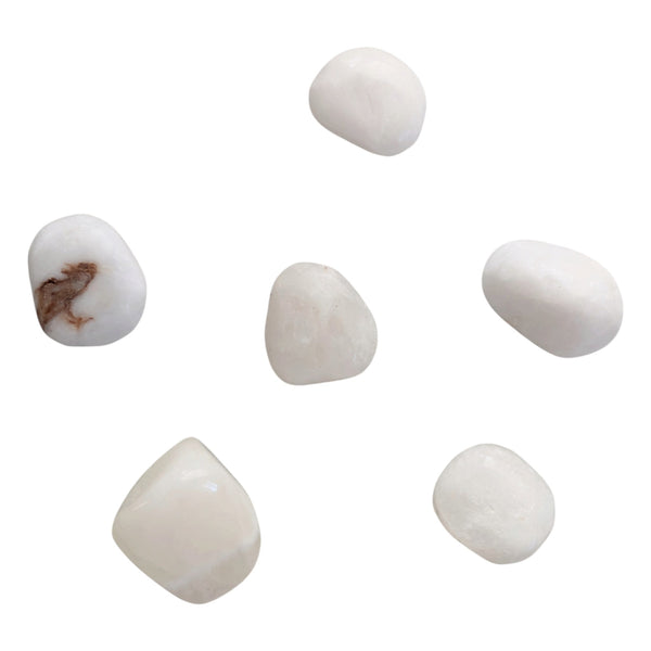 white anhydrite gemstones, some with brown inclusions