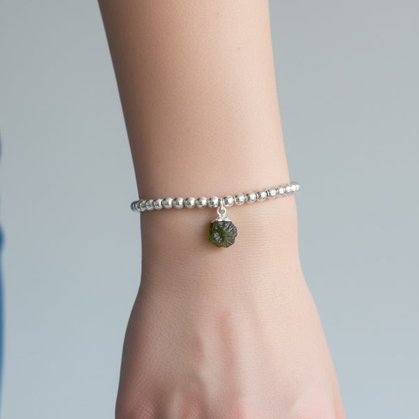 Silver plated beaded bracelet with small natural peridot charm attached. 
