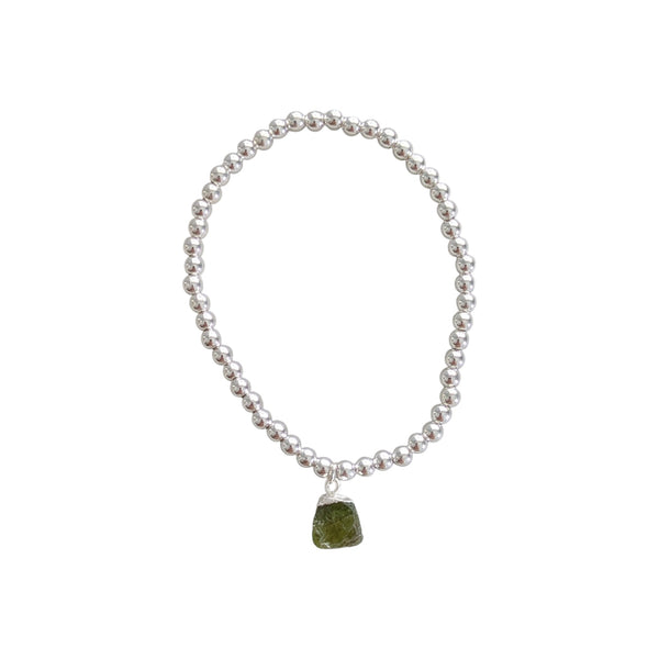 Silver plated beaded bracelet with raw peridot charm attached. 