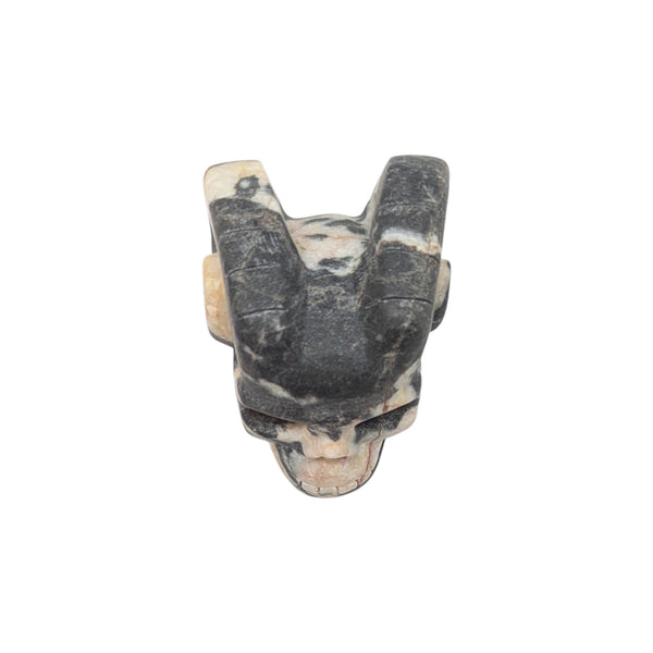 small crystal skull with horns carved from pink zebra jasper