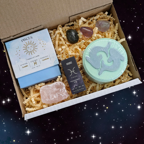 Gift Box curated for those born under the sign of Pisces including; Pisces crystal candle, Pisces bath bomb, Pisces fragrance oil, crystal tumblestones and a piece of raw rose quartz. 