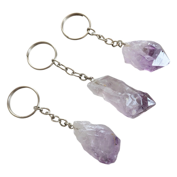 Natural raw amethyst point keychains featuring light to dark purple hues