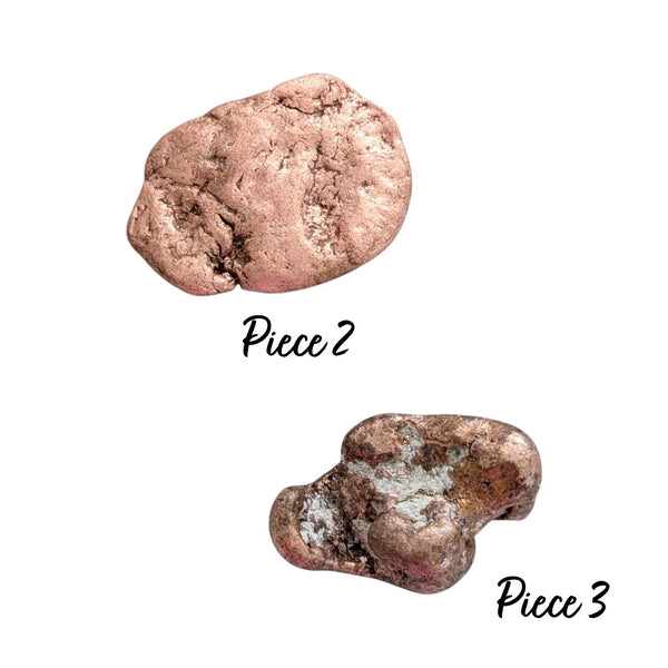 Two pieces of Native Copper, one piece is a smooth, flat specimen formed when copper was hydraulically injected into a narrow bedrock fault line. The other is a dense, heavy nugget featuring a striking inclusion of bright white quartz or calcite matrix locked right into its centre.