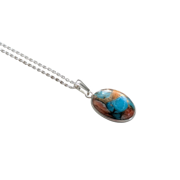 oval pendant with Spiny Oyster Turquoise showing the different colours of the shell and turquoise and matrix. 
