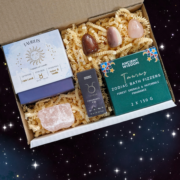 A curated astrology-themed gift box set containing a Taurus candle, a Taurus bath fizzer, Taurus crystal scented candle, and crystals. 