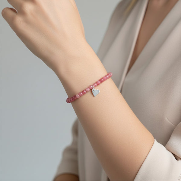 Thulite faceted crystal beaded bracelet with 925 sterling silver heart charm attached. 